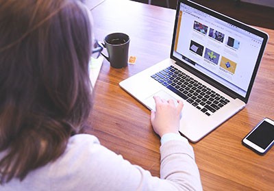 A woman is working on laptop