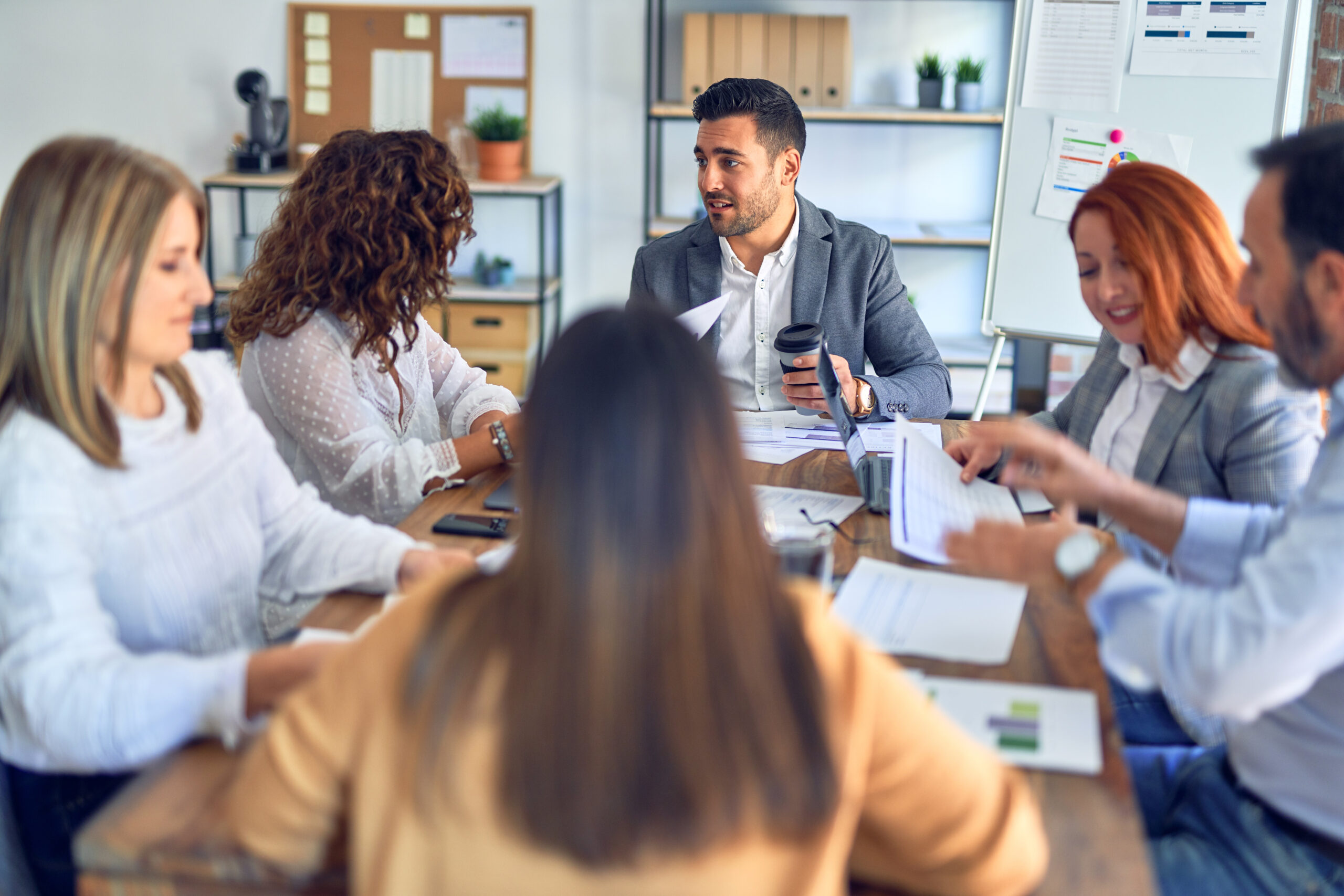 Group,Of,Business,Workers,Working,Together.,Sitting,On,Desk,Using